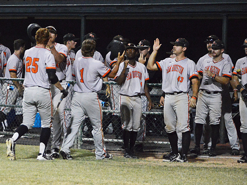 Sam Houston State's Jordan Cannon (25) and Mac Odom (1) are congratulated by teammates after scoring in the top of the ninth inning to tie it 4-4 against Incarnate Word on Thursday night. - photo by Joe Alexander