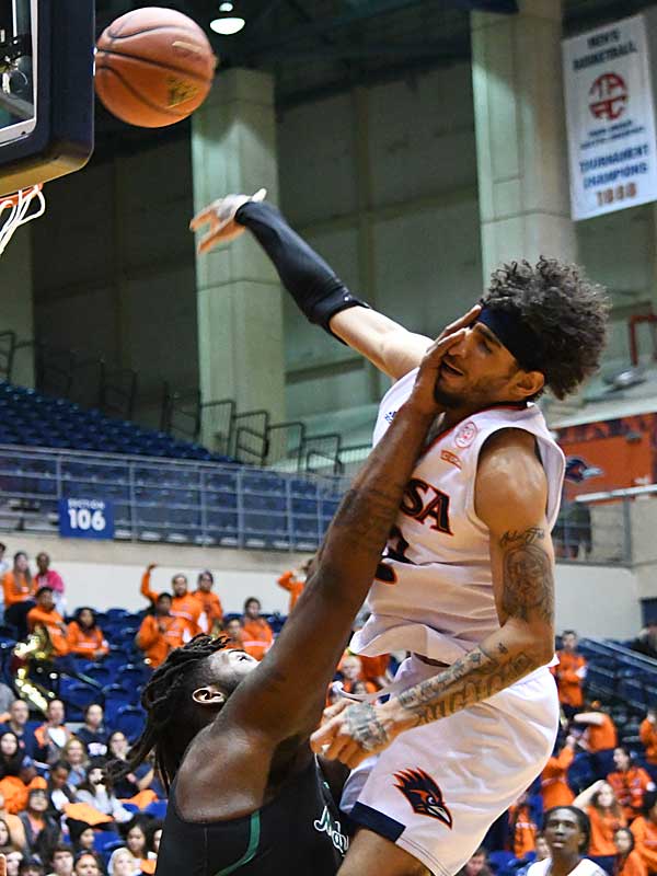 UTSA's Jhivvan Jackson gets smacked in the face by Marshall's Iran Bennett while putting up a shot. Jackson had 25 points and 10 rebounds in UTSA's 72-63 Conference USA victory over Marshall on Thursday at the UTSA Convocation Center. - photo by Joe Alexander