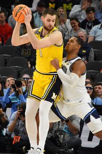 Michigan's Hunter Dickinson and Villanova's Eric Dixon. No. 2 seed Villanova beat No. 11 seed Michigan 63-55 in the NCAA tournament South Region Sweet 16 on Thursday, March 24, 2022, at the AT&T Center. - photo by Joe Alexander